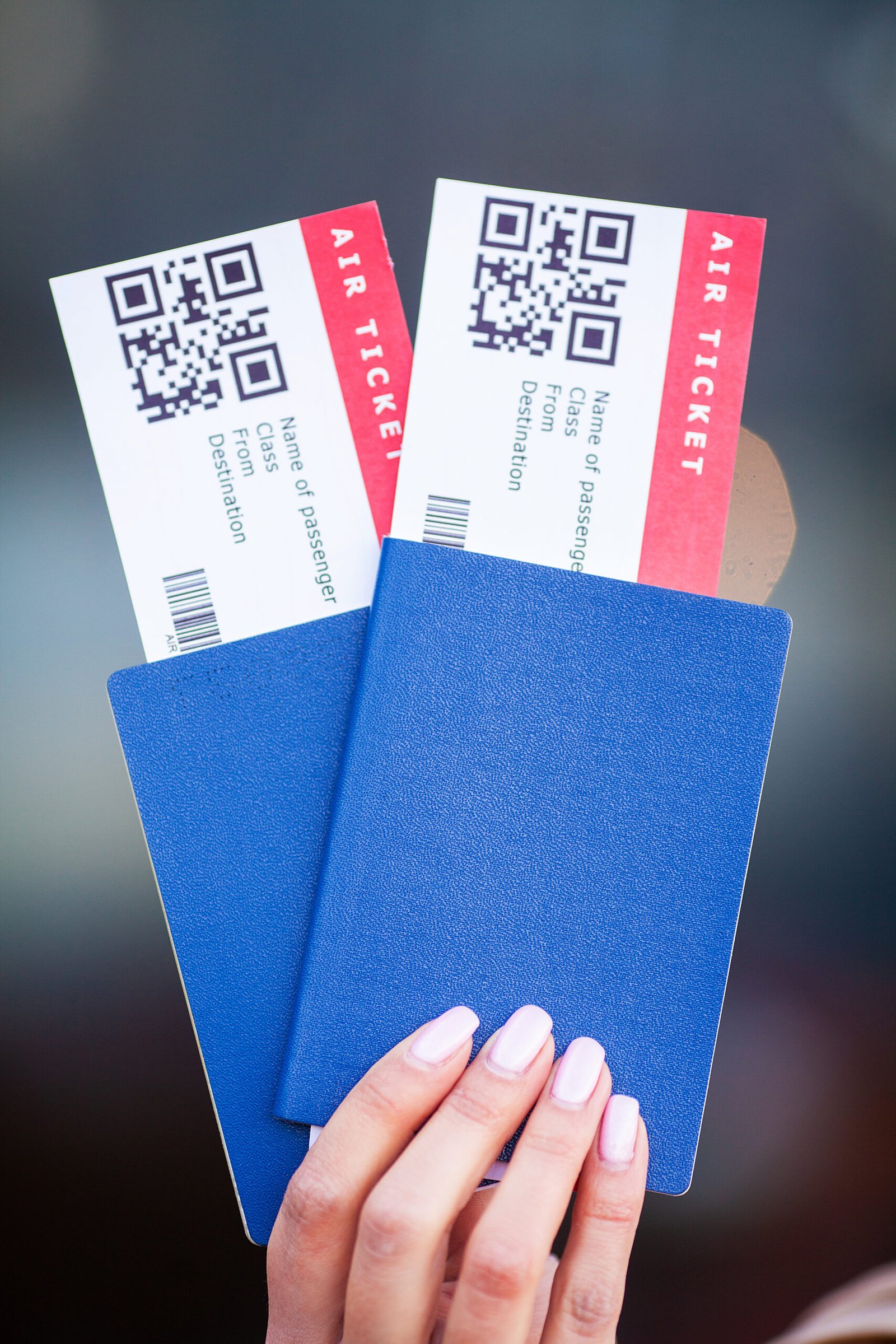 Passports And Tickets For Flight On Hand Of Woman